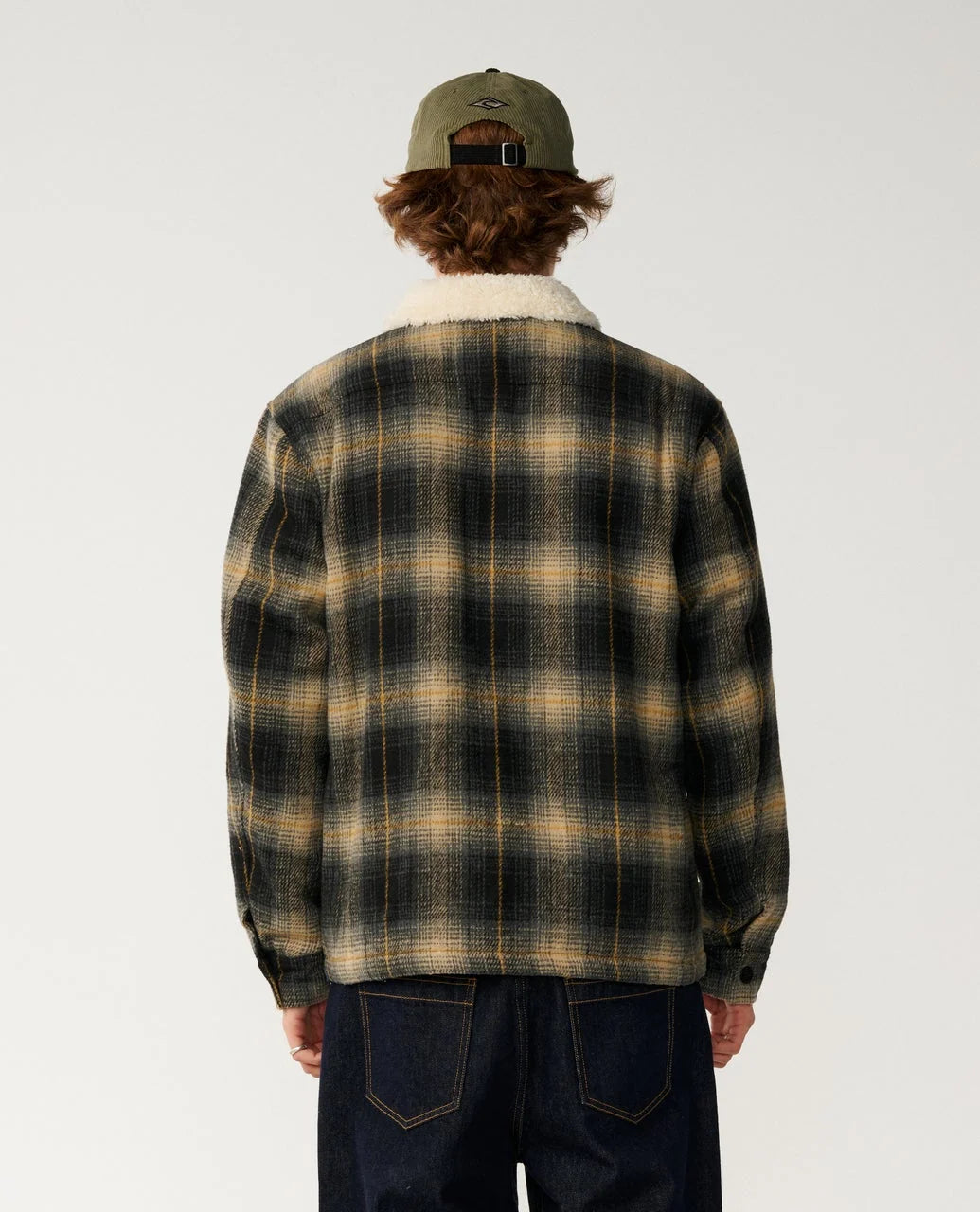 Back view of plaid sherpa-collar snap jacket with full-length sleeves.