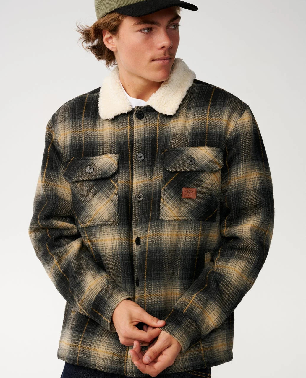 Plaid sherpa-collar snap jacket with chest pockets and orange label patch.