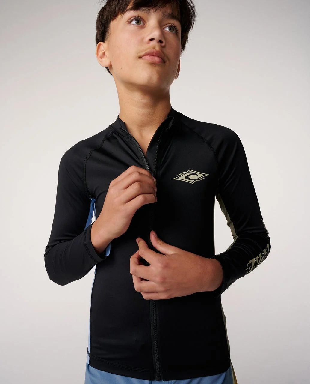 Junior long-sleeve zip rash guard in black, front zipper and chest logo