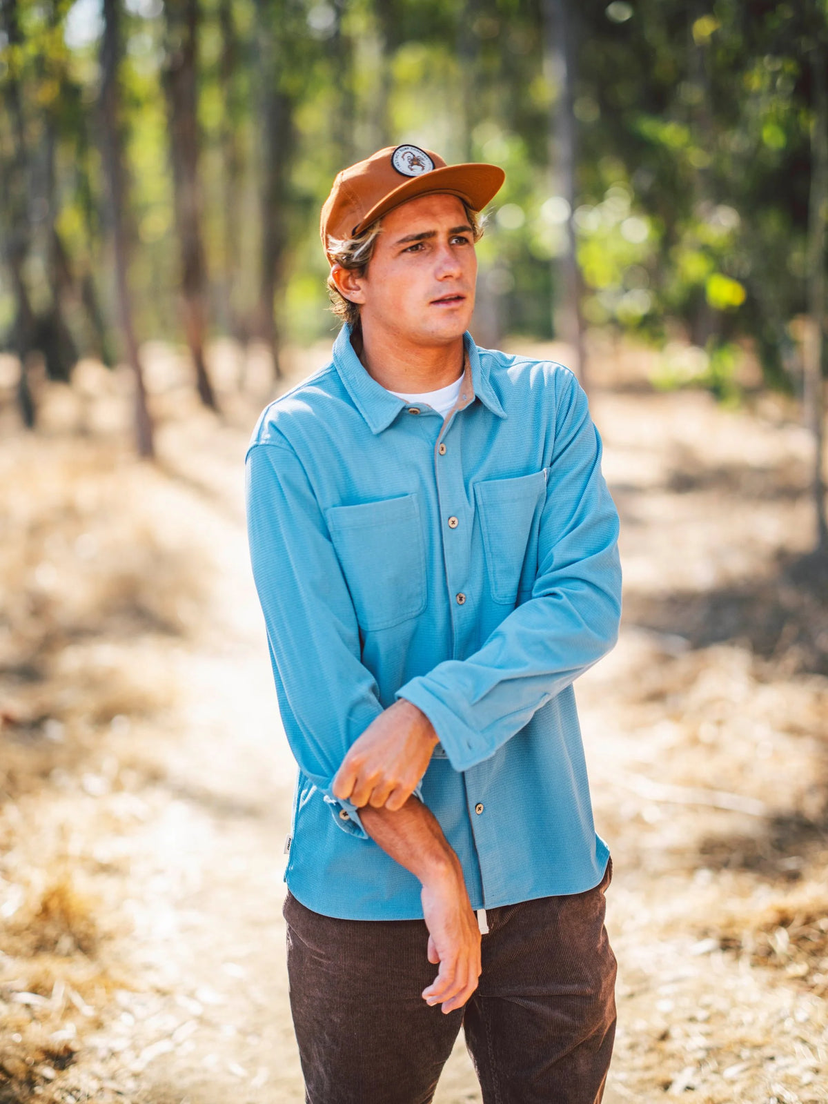 Slate blue shirt jacket worn by model with button front and chest pockets