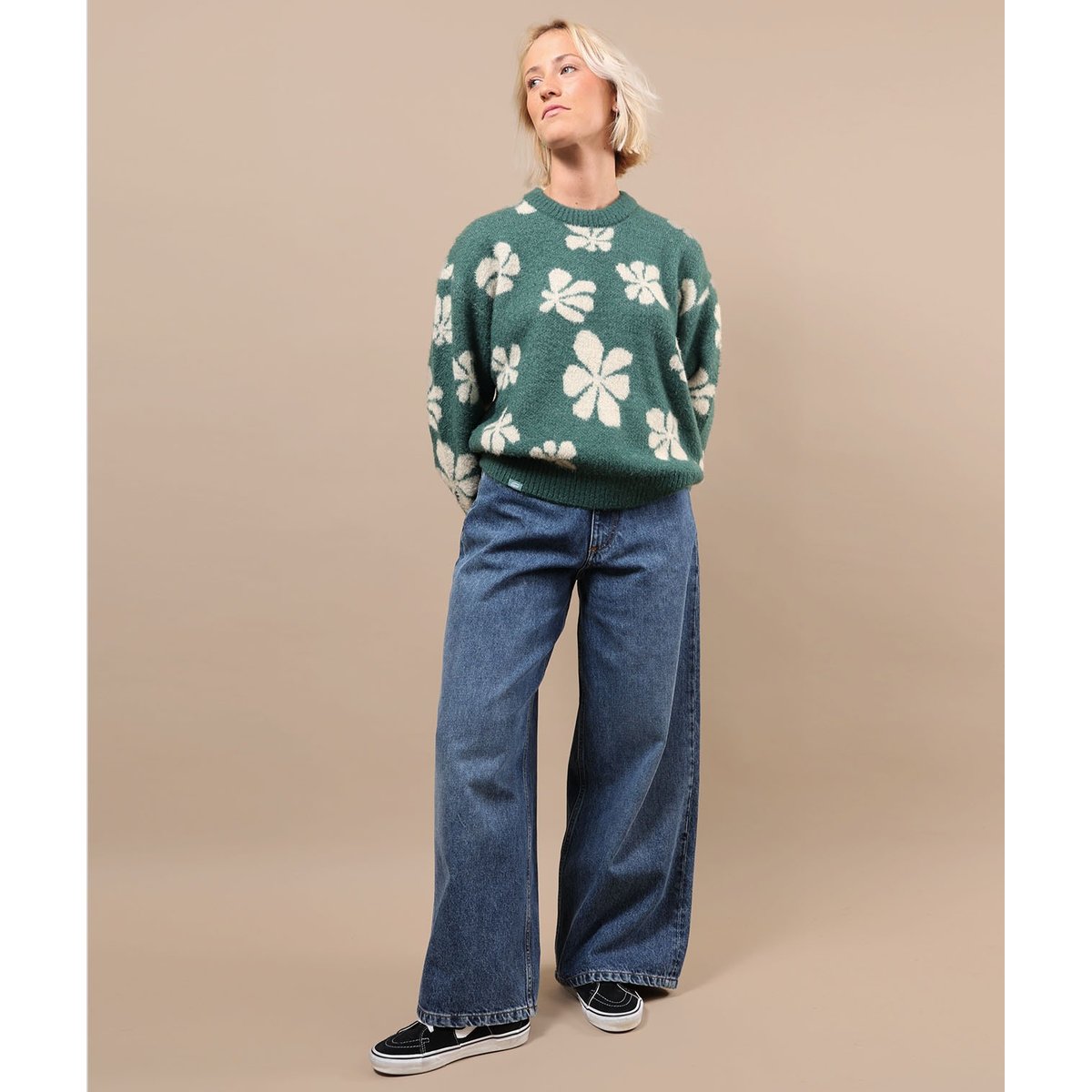 Green crewneck sweater with white floral pattern and ribbed waistband