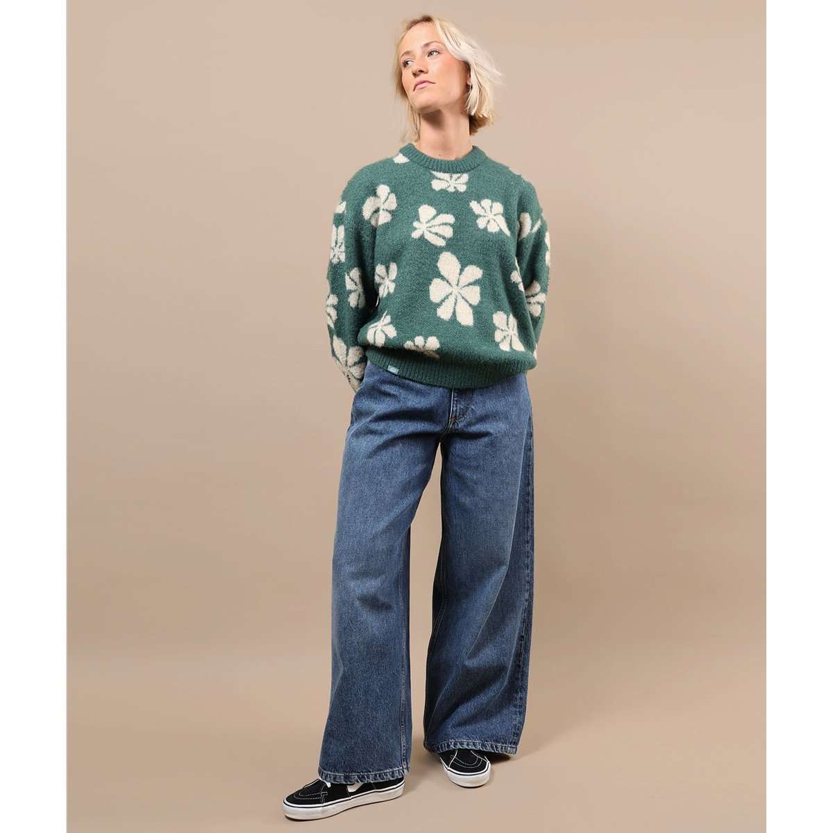 Green crewneck sweater with white floral pattern and ribbed waistband