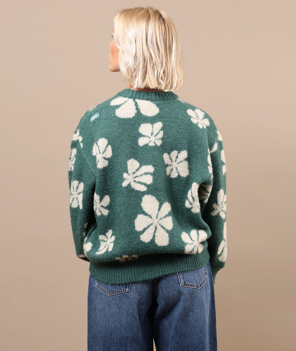 Green crewneck sweater with white floral pattern, ribbed cuffs and hem