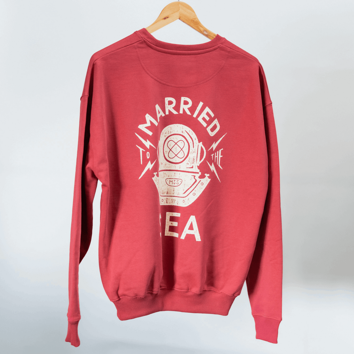 Red crewneck sweatshirt with large 'Married to the Sea' graphic on front.