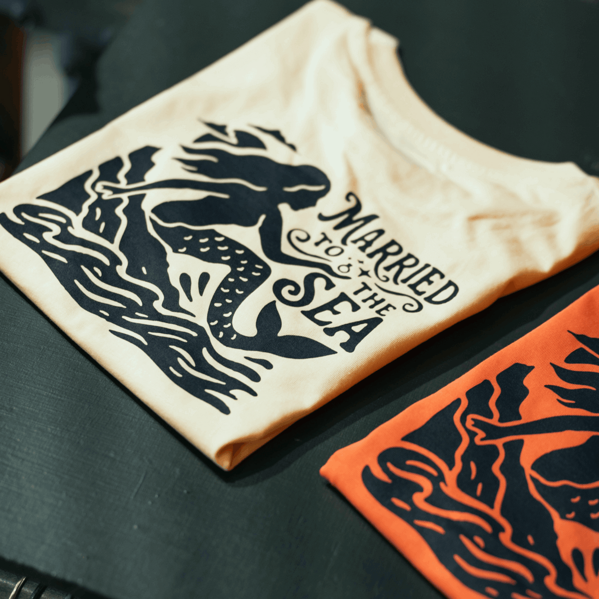 Women's cream T-shirt with dark mermaid graphic and Married to the Sea text