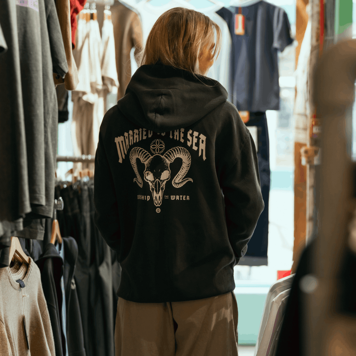 Faded black zip-up hoodie with back graphic and hood