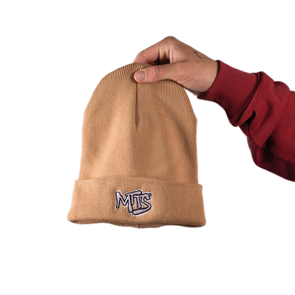 Latte ribbed beanie with folded cuff and MTS logo, held upright