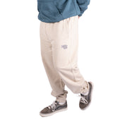 Desert Dust joggers with tapered cuffs and a small leg logo, shown from the side.